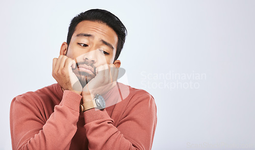 Image of Thinking, depression and sad asian man in studio for stress or broken heart, lonely or bored on grey background. Doubt, fear and face of male with anxiety, grief or trauma and mental health crisis