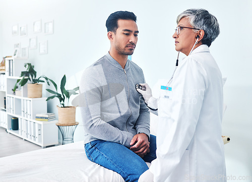 Image of Man, doctor and cardiology with stethoscope and senior professional at a hospital for health. Listening, consultation and patient at a heart clinic for expert advice and beat hearing for healthcare