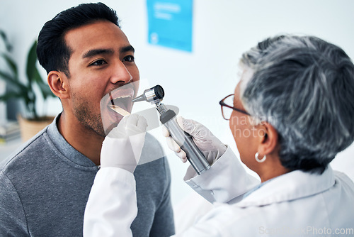 Image of Healthcare, consulting and doctor with person and throat in hospital for cancer, sick and surgery. Medicine, medical and check up with woman and patient in clinic for wellness, virus and mouth exam