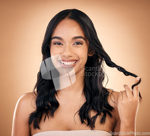 Image of Portrait, hair and beauty with a model woman in studio on a brown background for shampoo treatment. Smile, salon and haircare with a happy young person looking confident about natural cosmetics