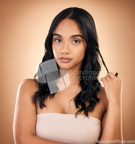 Image of Portrait, serious woman and hair care, beauty and curly isolated in studio on a brown background. Face, natural cosmetics and female model with salon treatment for aesthetic, wellness and hairstyle.