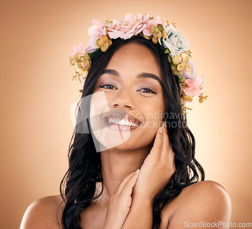 Image of Portrait, beauty and flower crown with a model woman in studio on a brown background for shampoo treatment. Smile, salon and hair with a happy young person looking confident about natural cosmetics