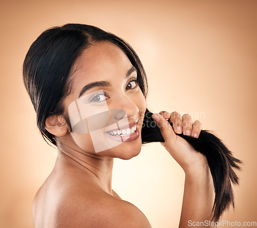 Image of Portrait, strong hair and beauty with a woman in studio on a brown background for shampoo treatment. Face, salon and haircare with a happy young female model looking confident about natural cosmetics