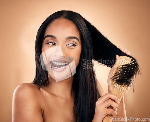 Image of Hair care, brush and excited woman with beauty in studio isolated on a brown background. Salon, happy and model with wood grooming product for natural aesthetic, hairdresser or hairstyle for wellness