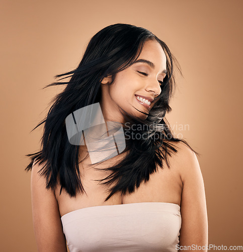 Image of Beauty, hair and smile with woman in studio for skincare, salon treatment and keratin. Shampoo, wellness and self care with face of female model on brown background for cosmetics, collagen and glow