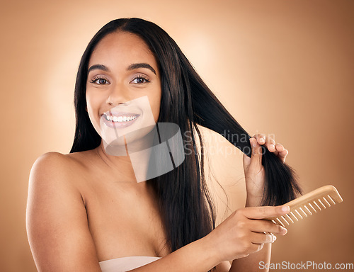 Image of Hair care, comb and portrait of woman, smile and isolated on a brown background in studio. Salon, face and beauty of model with a product for natural aesthetic, hairdresser and hairstyle for wellness