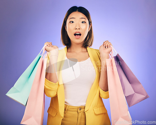 Image of Wow, surprise and portrait of woman with shopping bag from a sale, promotion or customer with deal on retail clothing. Face, Asian model with shock, emoji or crazy discount on luxury product or store