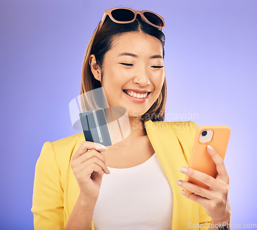 Image of Woman, phone and credit card of e commerce, online shopping or fintech payment on studio purple background. Fashion sale and happy asian person on internet banking, subscription or mobile transaction