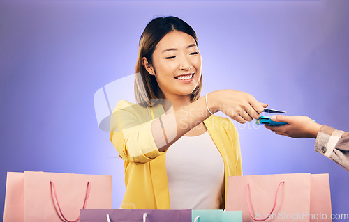 Image of Card machine, shopping bag and woman POS, online payment and digital service or fashion fintech. Retail credit and cashier hands, asian customer or people at point of sale on studio purple background