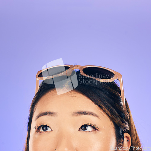 Image of Thinking, face and woman with sunglasses for summer, vacation or idea for holiday on purple studio background. Choice, decision and Asian model with glasses on head for beach, style or fashion