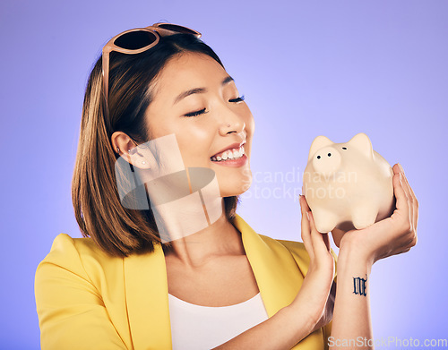 Image of Piggy bank, finance and woman thinking of savings, investment and happy for money growth goals. Young asian person for financial management, money safe or banking security on studio purple background