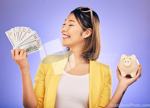 Image of Piggy bank, money and woman with savings, financial investment and profit, increase or budget success. Excited Asian person with banking notes, cash and safe or container on studio purple background