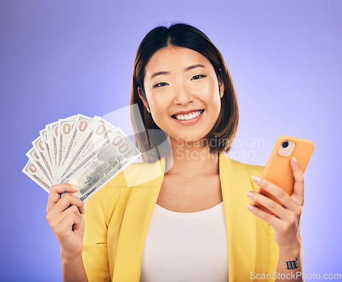 Image of Money, phone and woman in portrait winning, finance or online savings, profit and cash prize. Success, lottery and winner or asian person on mobile, money fan and banking on studio, purple background