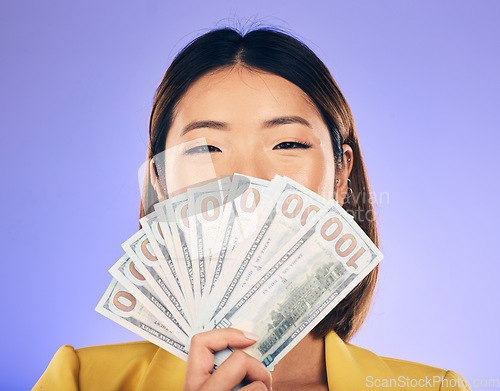 Image of Money, beauty and woman cover face on purple studio background for winning, cash fan or financial prize. Lottery, bank and asian person or winner bonus, cosmetics secret or finance profit in portrait