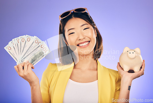 Image of Piggy bank, portrait and woman with money savings, financial investment and profit, increase or budget success. Asian person with banking notes, cash and safe or container on studio purple background