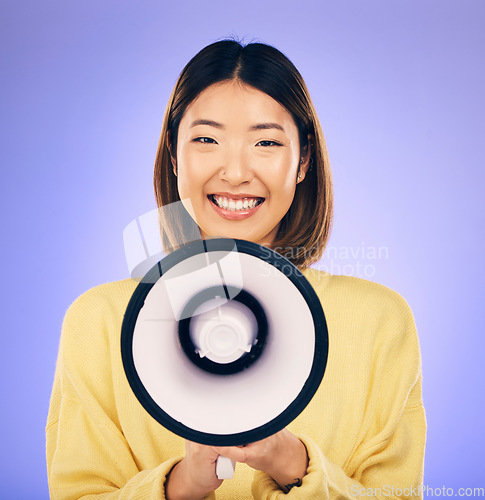 Image of Woman, megaphone and happy portrait in studio for announcement, voice or broadcast. Face of a young asian female speaker with a loudspeaker for communication, message or speech on purple background