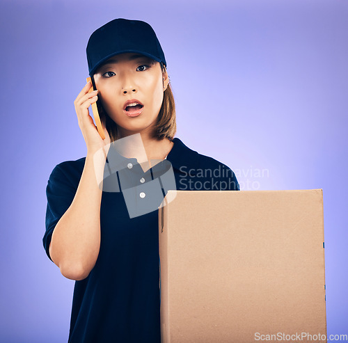 Image of Asian woman, phone call and box for delivery, courier service or logistics against a purple studio background. Portrait of female person talking on mobile smartphone with package, parcel or order