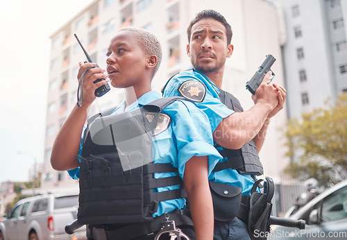 Image of Team, gun and police in the city for crime, talking into equipment and ready for action. Security, law and a black woman and man speaking into gear while in collaboration for criminal activity
