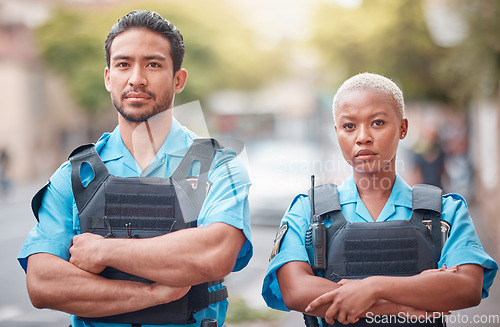 Image of People, police and arms crossed in city for law enforcement, safety and protection outdoors. Portrait of man and woman cop or security guard in teamwork to protect and serve the community in town