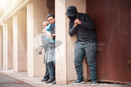 Image of Police, criminal and gun taking cover for security, backup or law enforcement outside house. Man, woman cop and dangerous robber with weapon in crime for justice, investigation or protection service