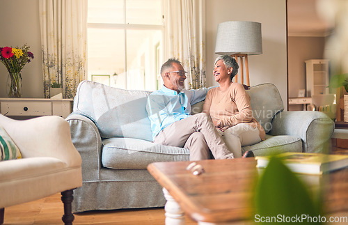 Image of Couch, love and senior couple relax and laugh together in a home for a conversation and bonding on retirement. Elderly man and woman in a living room for happiness, joke and happy in a marriage