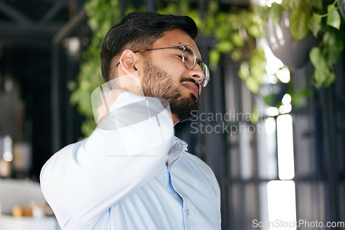 Image of Business man, neck pain and problem with health issue and muscle fatigue in a office. Employee, young male person and professional and injury of worker feeling tired from inflammation at work