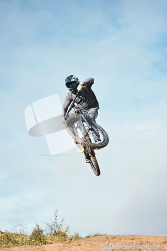 Image of Mountain, bike jump and person cycling on bicycle for extreme sports competition stunt or training in nature. Skill, contest and athlete workout or practice sky trick for fitness with mockup space