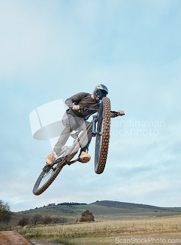 Image of Cycling, fitness and man with bicycle jump for extreme sports, energy and adrenaline in nature. Action, bike and cyclist in countryside with speed, trick and skill, adventure or power on mockup space