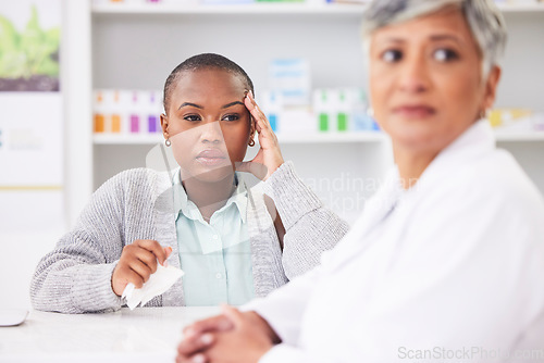 Image of Consultation, pharmacy and a black woman with a headache and a doctor for healthcare advice. Support, pharmacist and an African patient at a clinic with a migraine and medical worker for help