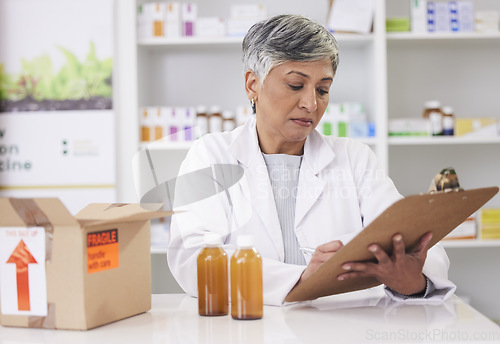 Image of Woman, doctor and clipboard at pharmacy for inventory inspection, logistics or delivery at drug store. Senior female person, medical or healthcare professional checking pharmaceutical stock or list