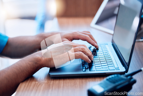 Image of Laptop, radio and hands of security typing or writing an investigation project at a law enforcement office. Police, keyboard and person or officer working on internet crime and criminal email online