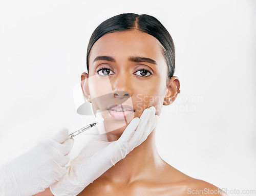 Image of Injection, scared and portrait of woman with face filler of beauty process on white background in studio. Cosmetics, indian female model and fear of needle, plastic surgery or aesthetic facial change