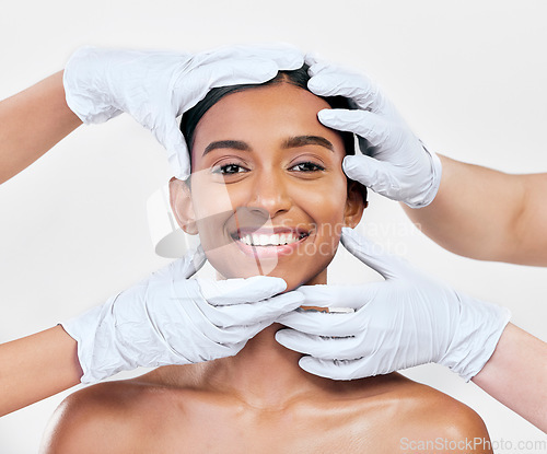 Image of Woman, plastic surgery and gloves in studio portrait with smile for skin, inspection or change by white background. Girl, model and doctors hands for transformation, cosmetics and facial aesthetic