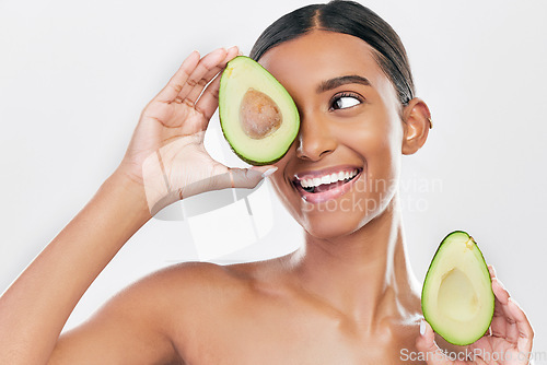 Image of Avocado, skincare and happy, beauty woman isolated on a white background for healthy facial and cosmetics ideas. Indian woman or model thinking of vegan, eco friendly or dermatology product in studio