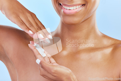 Image of Closeup, woman and cosmetics with cream, dermatology and self care against a blue studio background. Zoom, female person and model with lotion, grooming and natural beauty with skincare and wellness