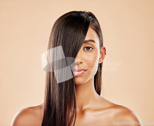 Image of Hair care, cosmetics and portrait of a woman on a studio background with salon treatment. Beauty, healthy and headshot of an Indian model or girl showing shampoo results isolated on a backdrop