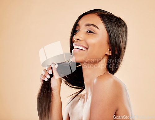 Image of Beauty, hair care and woman laughing in studio with natural glow and shine. Hairstyle, cosmetics and wellness of a happy Indian person for hairdresser, makeup or salon results on a beige background