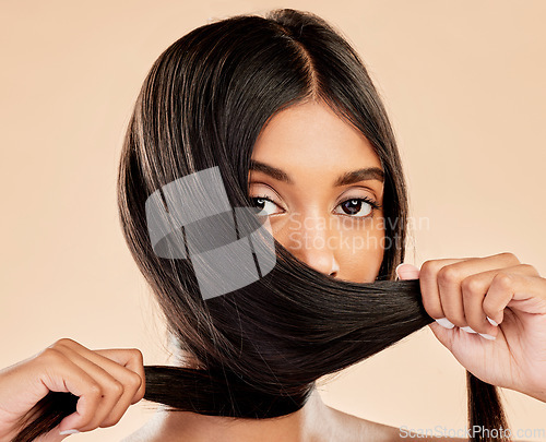 Image of Hair care, strong and portrait of a woman on a studio background for keratin, shampoo or hairdresser. Salon, health and an Indian girl or model showing hairstyle shine isolated on a backdrop
