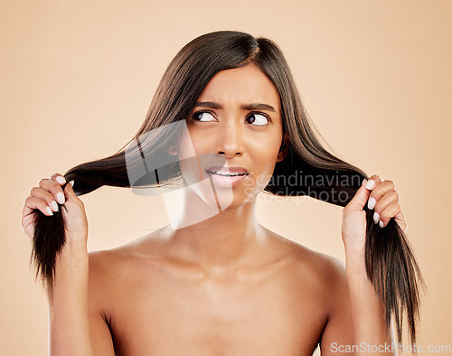 Image of Thinking, hair care and a woman with a problem on a studio background with anxiety and confused. Ideas, cosmetics and an Indian girl or model with hairstyle stress or fail isolated on a backdrop