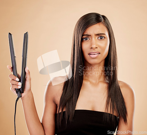 Image of Flat iron, hair and woman is confused with beauty, hairstyle and appliance fail on studio background. Keratin treatment, problem with electric straightener and female model with haircare crisis