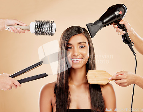 Image of Hair, electric tools and portrait of woman for beauty options on studio background. Happy indian female model with choice of aesthetic salon equipment with brush, hairdryer and flat iron for makeover