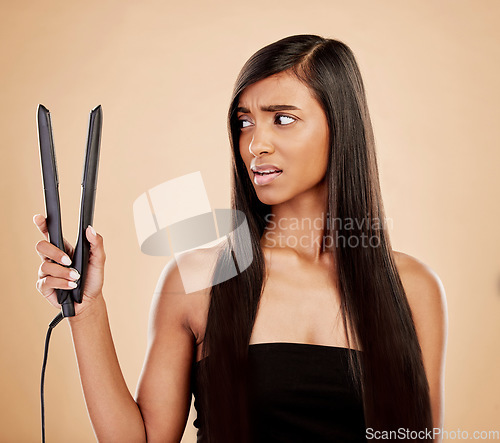 Image of Hair straightener, woman is scared and beauty, hairstyle and appliance fail on studio background. Keratin treatment, problem with electric flat iron and female model, haircare crisis and treatment