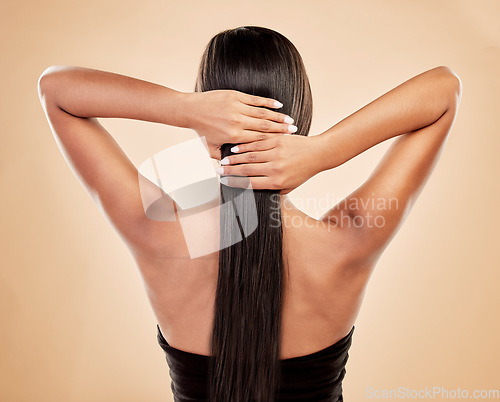 Image of Hands on hair, back view and woman with beauty, cosmetics and keratin treatment isolated on studio background. Female model, haircare and growth with texture, cosmetology shine and salon hairstyle