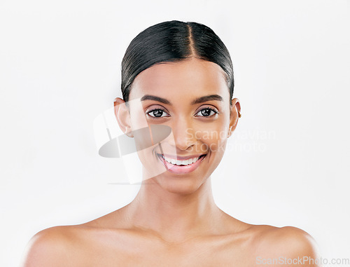 Image of Beauty, face and portrait a happy woman with natural skin care isolated on a white background. Dermatology, makeup glow and cosmetics with Indian female model for facial shine and self love in studio