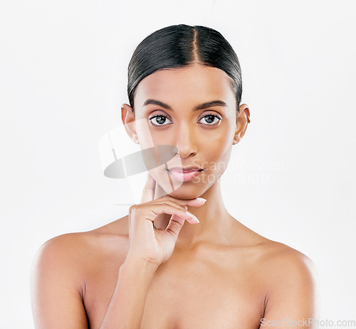 Image of Beauty, face and portrait of serious woman with natural skincare isolated on a white background. Dermatology, makeup glow or cosmetics with Indian female model for facial shine or self love in studio