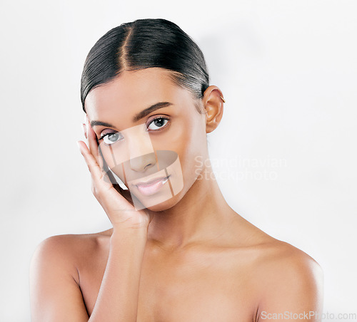 Image of Beauty, skin and face portrait of a woman with natural glow isolated on a white background. Dermatology, makeup and cosmetics of Indian female model for facial shine, wellness or self care in studio