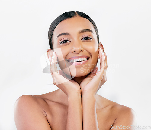 Image of Beauty, skin and face portrait of a happy woman with natural glow isolated on a white background. Dermatology, makeup and cosmetics of Indian female model for facial shine or self care in studio