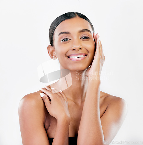 Image of Beauty, touch and face portrait of a happy woman with natural skin isolated on a white background. Dermatology, makeup and cosmetics of Indian person for facial glow, wellness or self care in studio