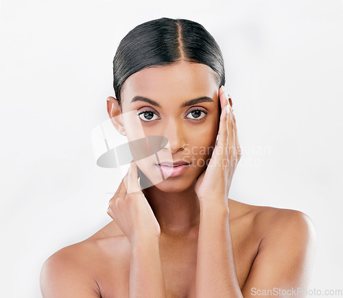 Image of Portrait, beauty and face of a serious woman with natural skin glow isolated on a white background. Dermatology, makeup or cosmetics of Indian person for facial shine, wellness or self care in studio