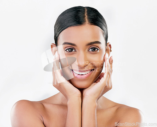 Image of Skin, beauty and face portrait of happy woman with natural glow isolated on a white background. Dermatology, makeup and cosmetics of Indian female model for facial shine, smile or self care in studio
